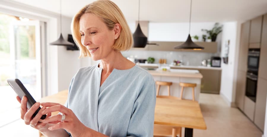 Resident using a cell phone in a room filled with sunlight